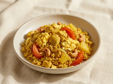 Illustration — pineapple fried rice with chicken, egg, pineapple and cashew in yellow curry.